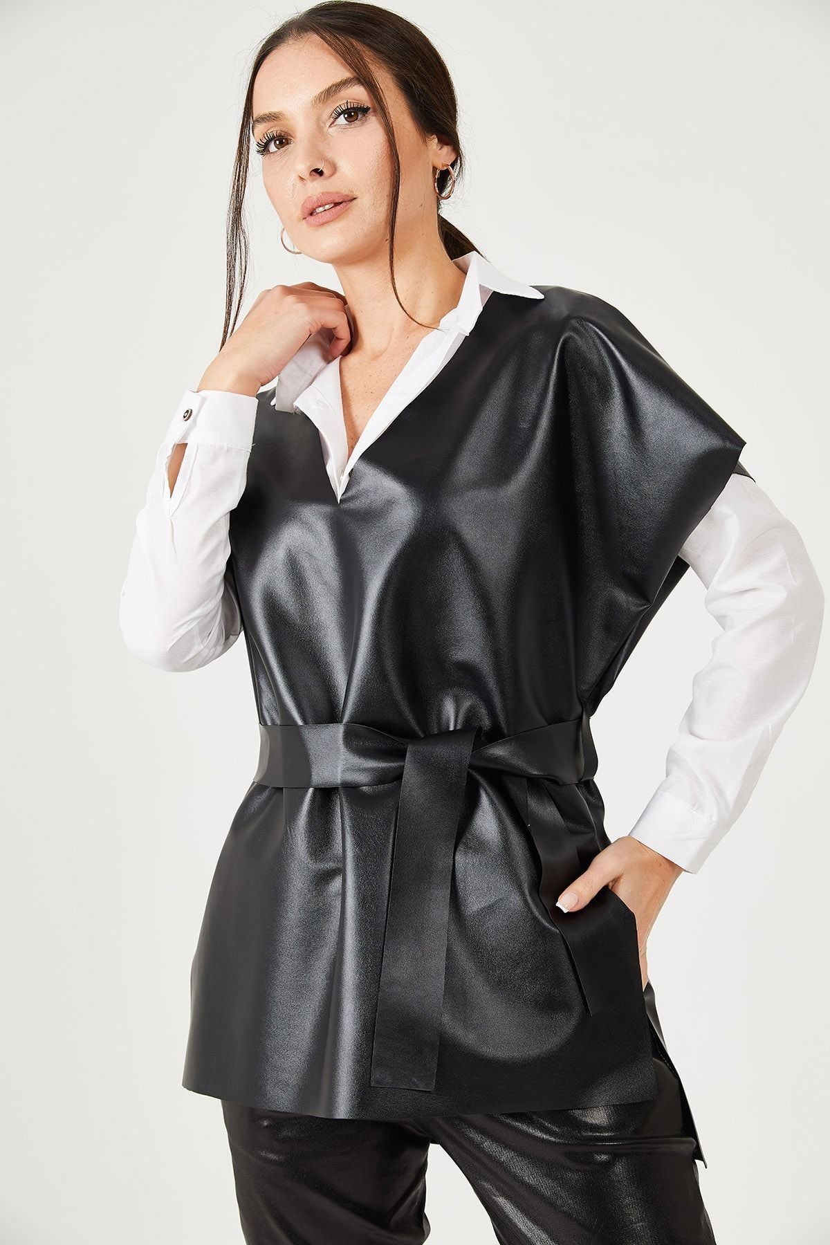 Female black v neck leather-looking front short back long-belted blouse ARM-21K001054