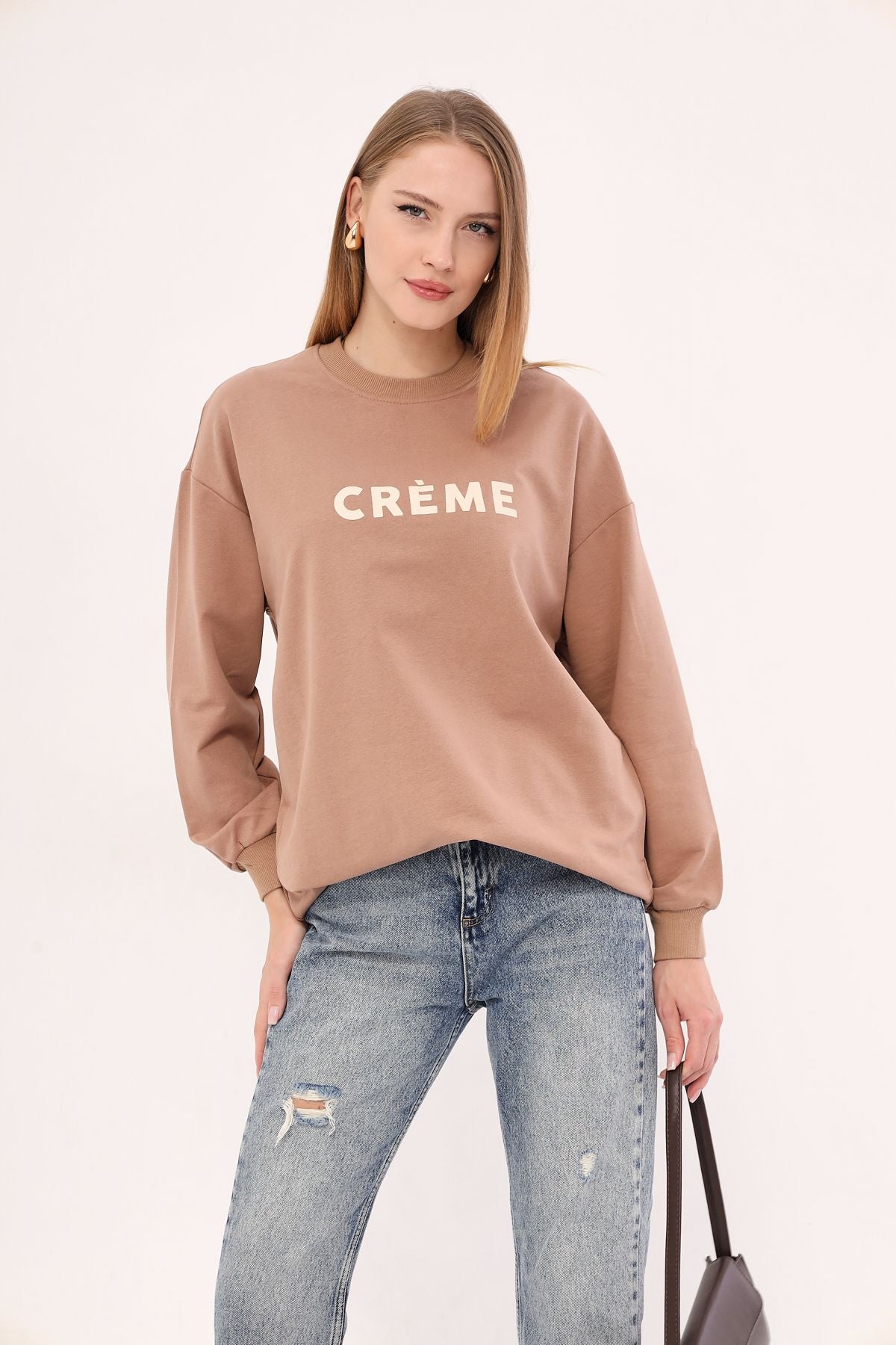 Female mink bike in front of the collar written Tunic Sweatshirt ARM-25K001029