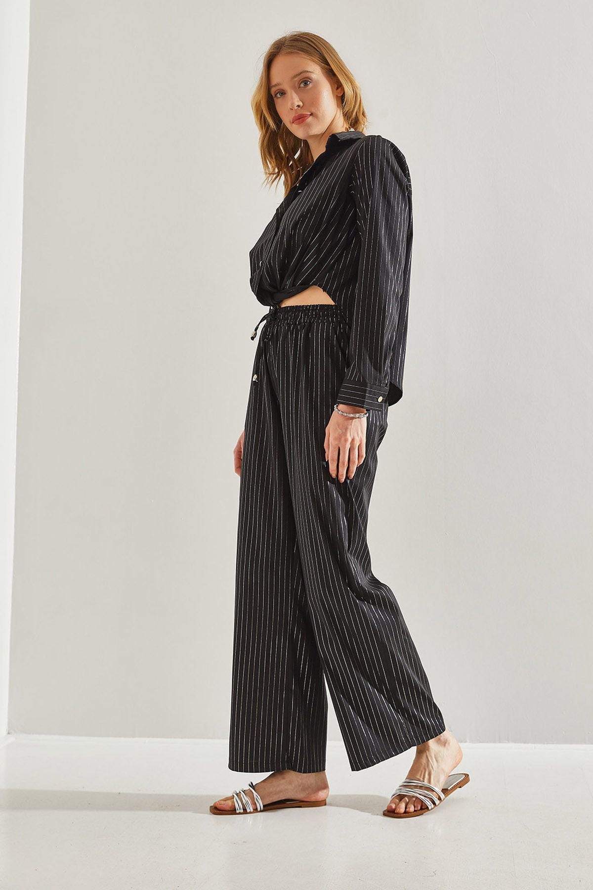 Female in front of a bright striped pants 60221021