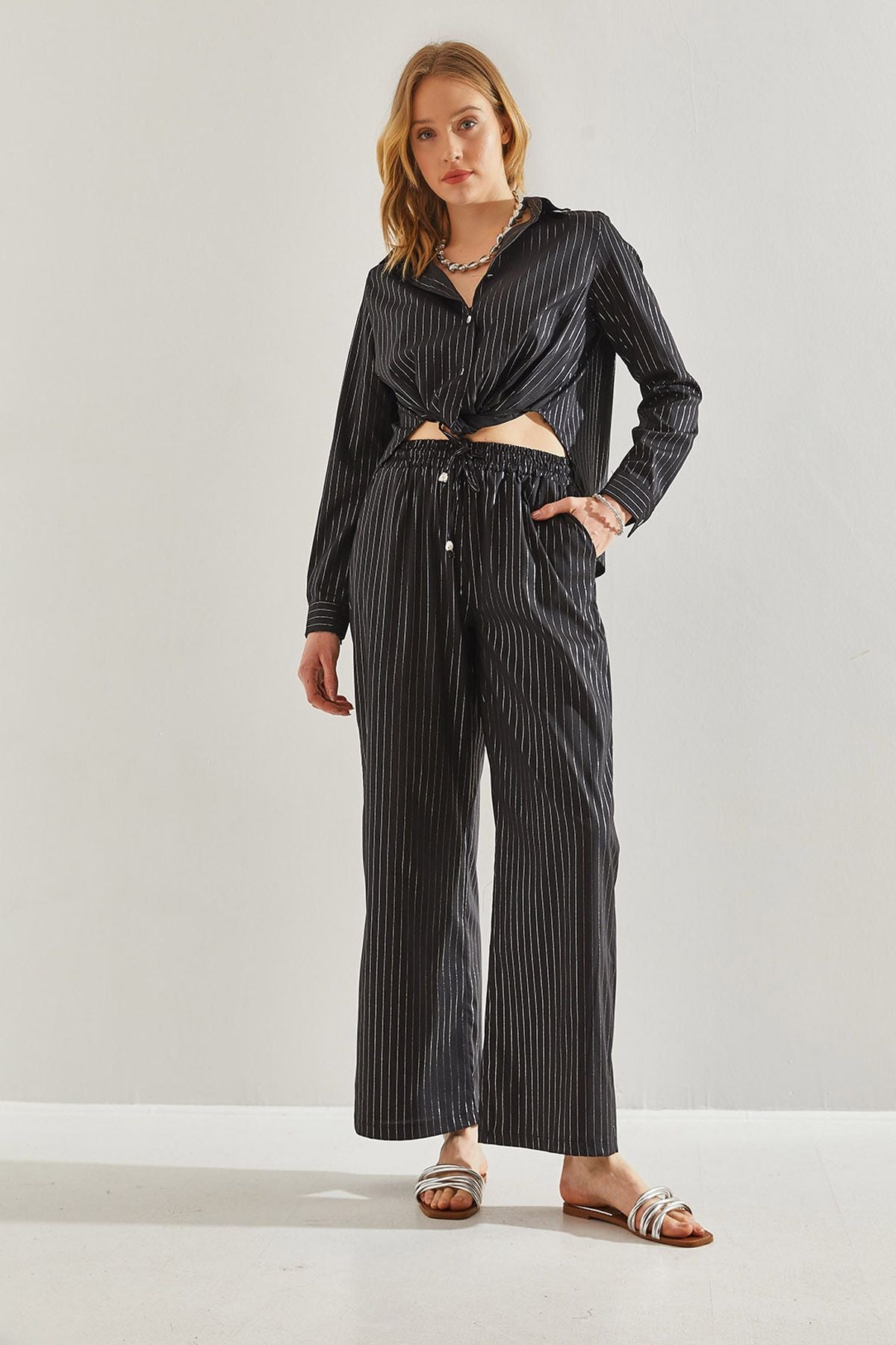 Female in front of a bright striped pants 60221021