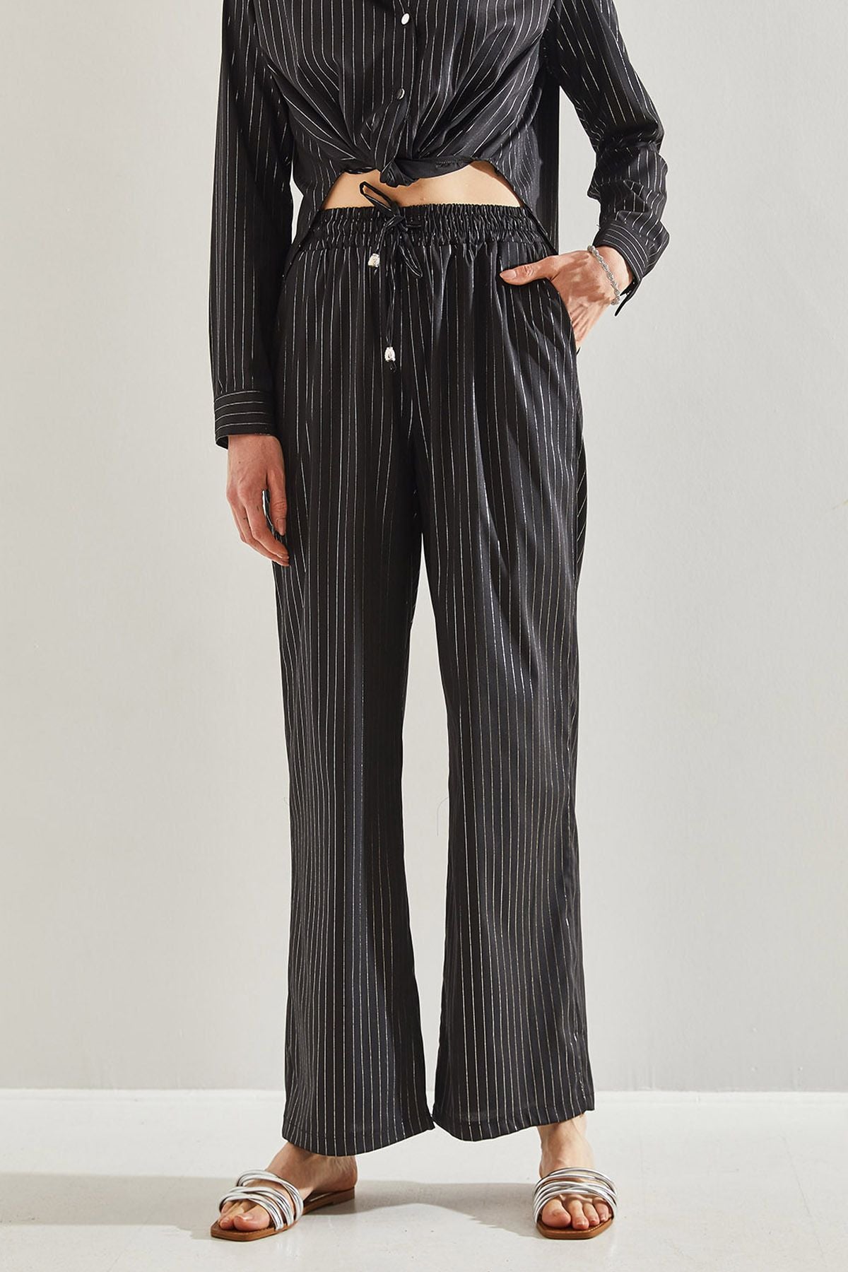 Female in front of a bright striped pants 60221021