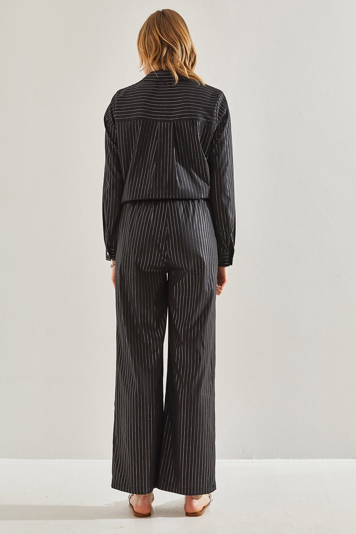 Female in front of a bright striped pants 60221021