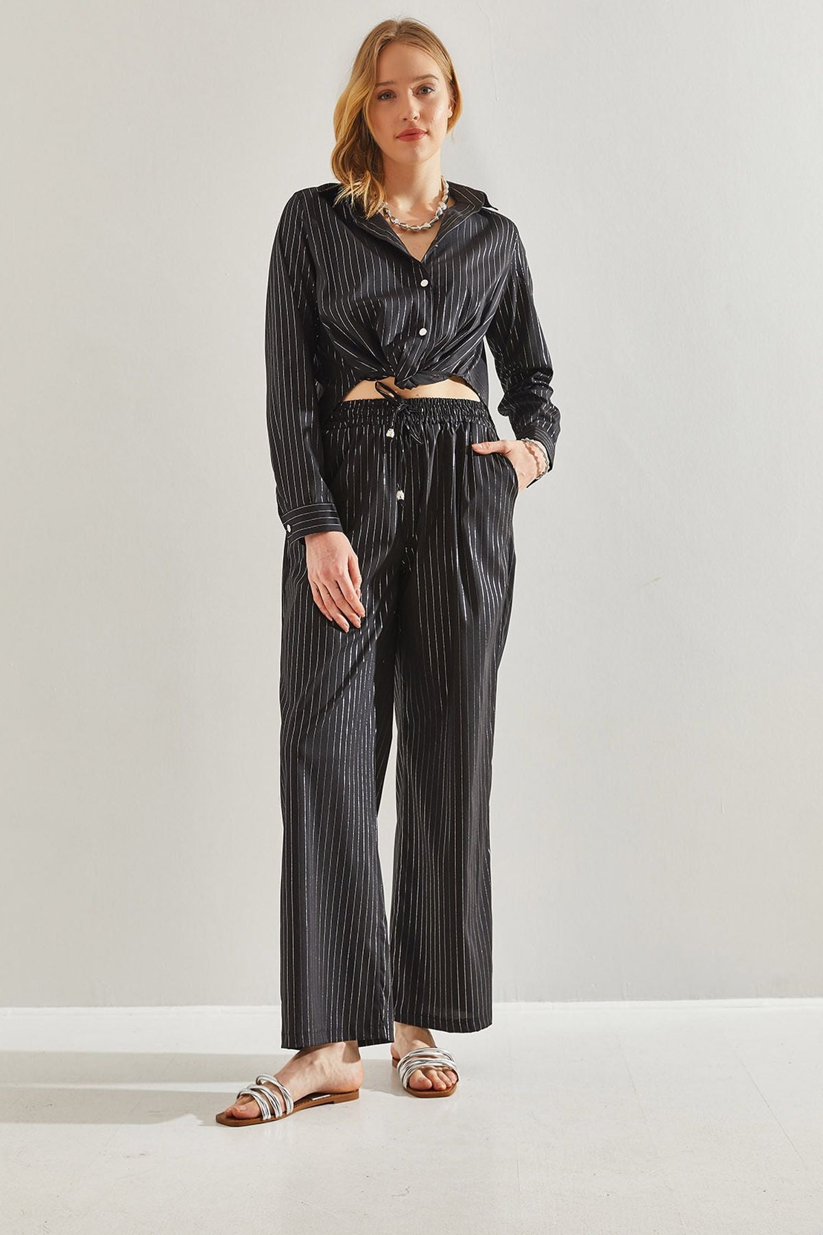 Female in front of a bright striped pants 60221021