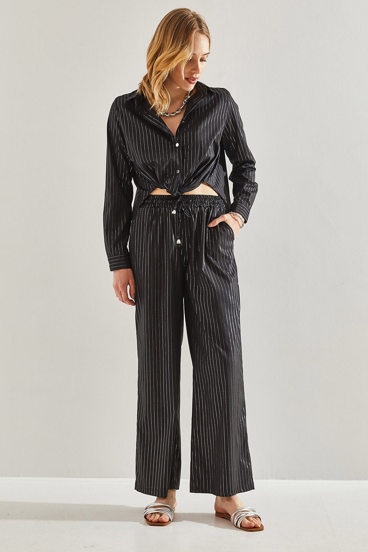 Female in front of a bright striped pants 60221021