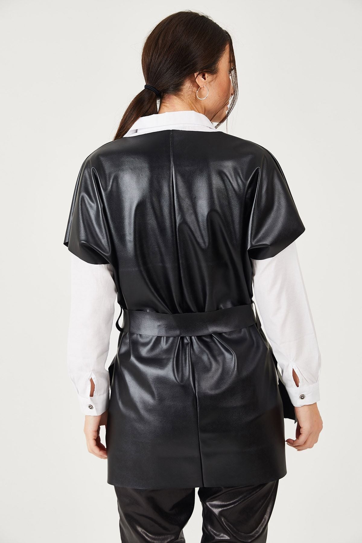 Female black v neck leather-looking front short back long-belted blouse ARM-21K001054