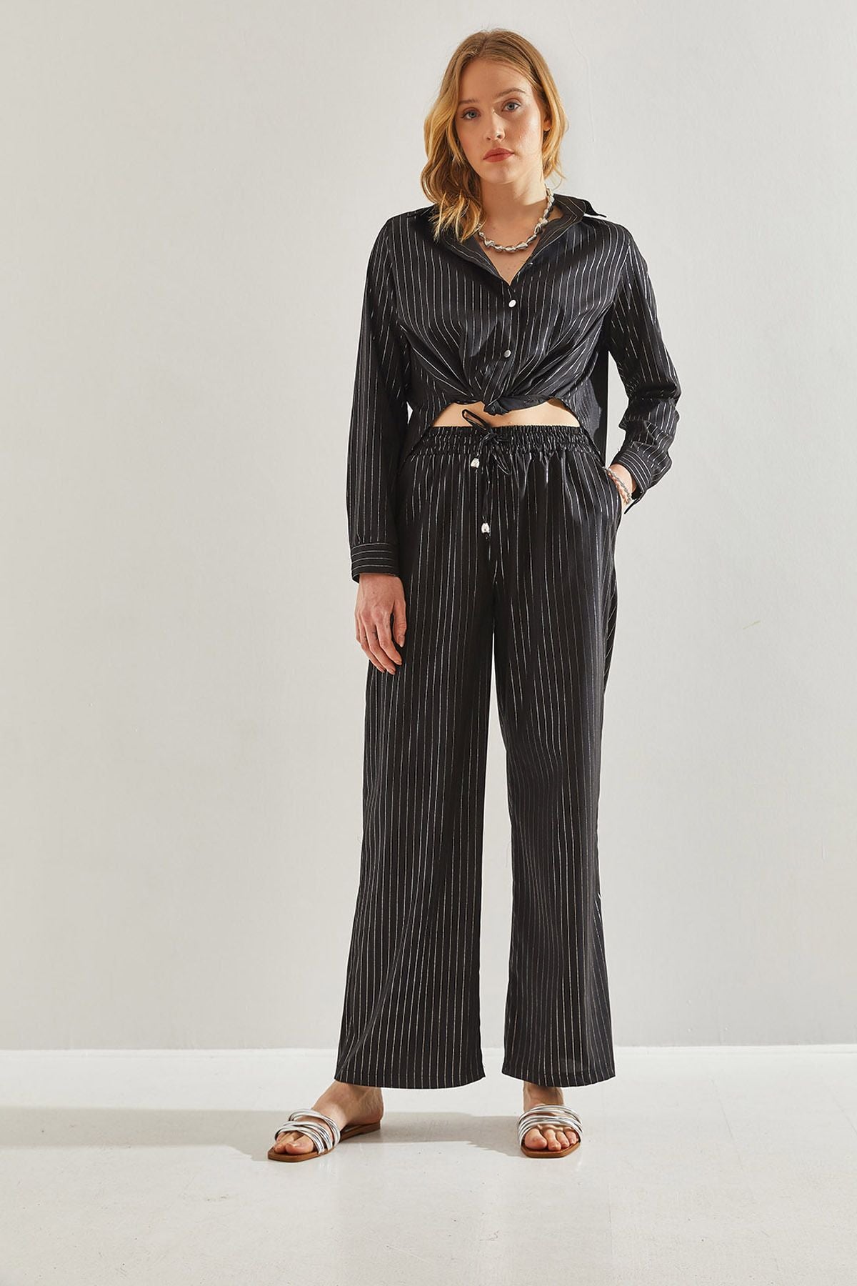 Female in front of a bright striped pants 60221021